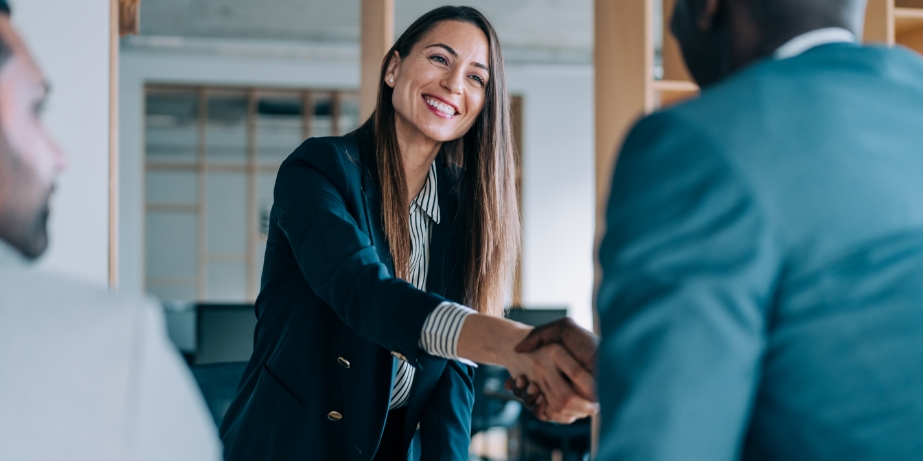 Woman shaking hands with client